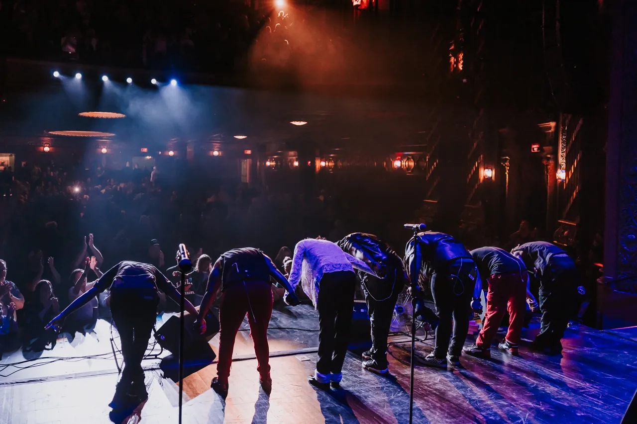 The Who’s Bad musicians and dancers take a bow together in front of the concert audience
